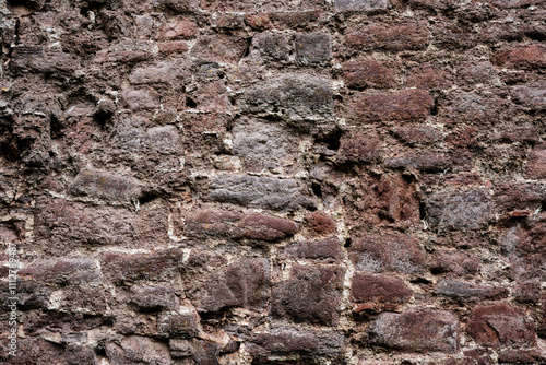 Obraz na płótnie A wall made of stone with a rough texture. The wall is brown and white w salonie