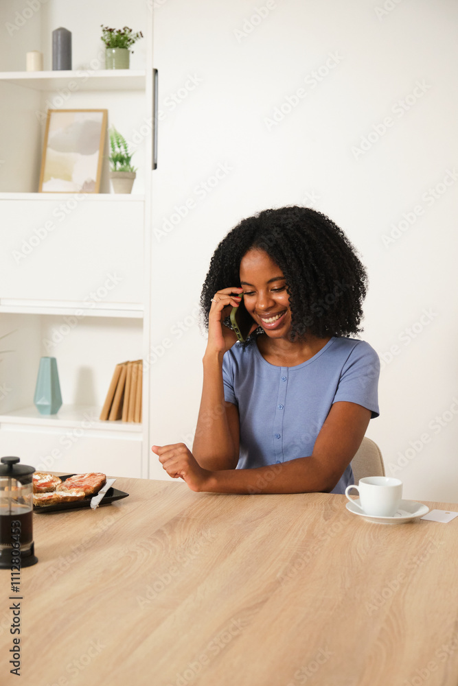 Young African American Woman Enjoying Phone Conversation at Home Young African American Woman Enjoying Phone Conversation at Home