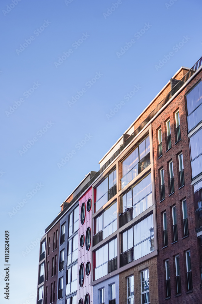Naklejka premium Modern residential building with colorful mural in Noblessner Tallinn on a clear day in 2024