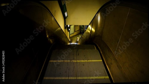 Close-up shot of the escalator of a subway in Rome, left image, cold colors.