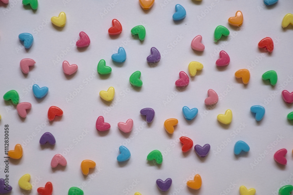 small multi colored hearts on white background small multi colored hearts on white background