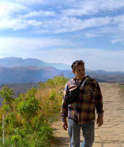 Hiker in the Mountains on a Sunny Day photo