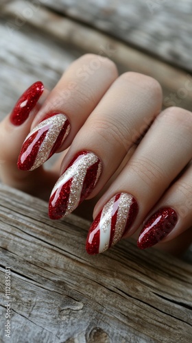 Nails adorned in red and gold design showcase festive elegance and creativity...
