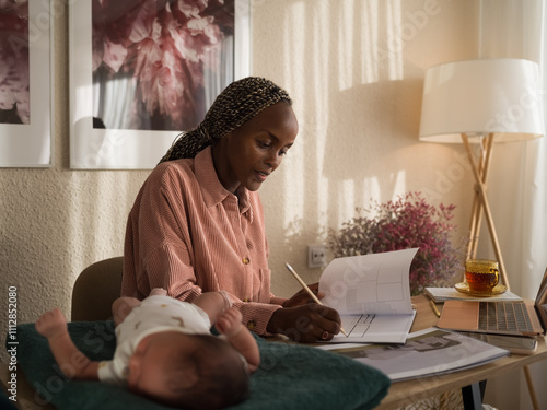 Professional architect working near newborn baby photo