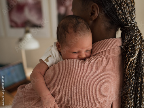 Mother singing lullaby to newborn baby  photo