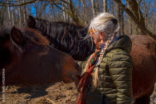 Lifestyle outdoor portrait senior woman at the horse ranch photo