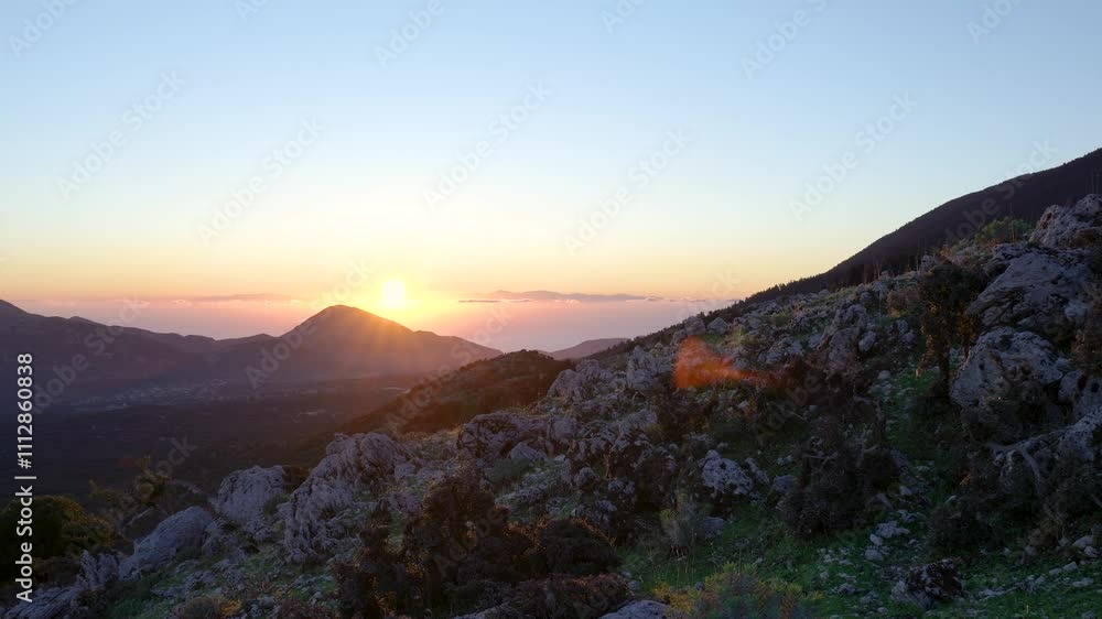 Sun setting behind mountain range in caldera de taburiente national park