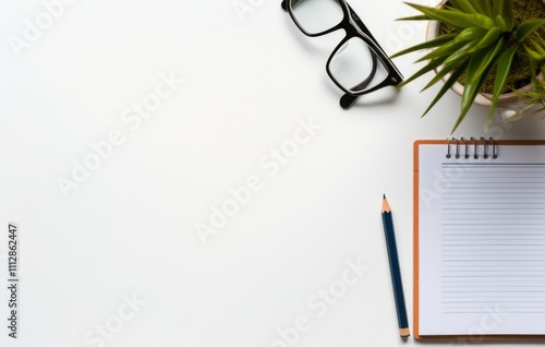 Blank notebook beside glasses and wheat stalks on wooden surface creating a c...