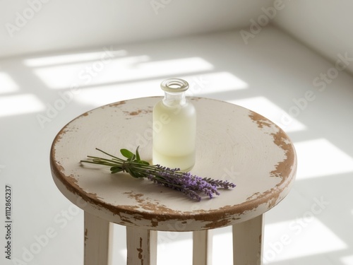 Glass Bottle of Essential Oil with Lavender Sprigs on a Wooden Table. photo