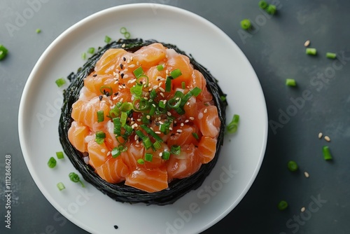 Fresh salmon salad with green onions and cilantro on a white plate