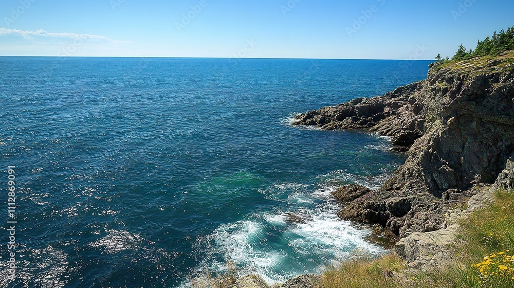 A serene ocean view from a cliff, with gentle waves lapping against the rocks and a clear blue sky above. A serene ocean view from a cliff, with gentle waves lapping against the rocks and a clear blue sky above.