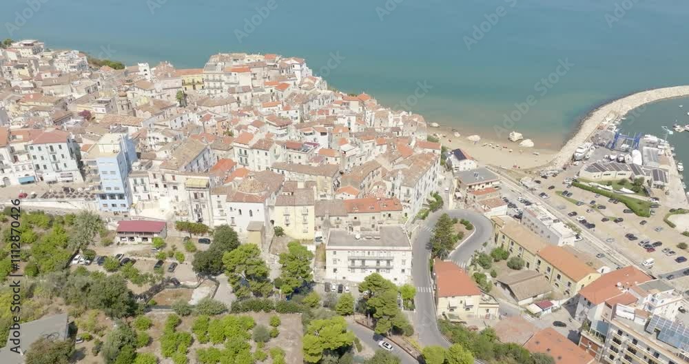 Aerial view of the town and the historic center of Rodi Garganico, located in Puglia, Italy, on the coast of the Adriatic Sea. It is a tourist destination in Gargano, in the province of Foggia. Aerial view of the town and the historic center of Rodi Garganico, located in Puglia, Italy, on the coast of the Adriatic Sea. It is a tourist destination in Gargano, in the province of Foggia.