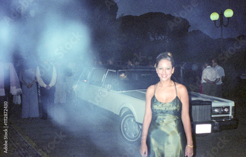 analog image of woman in an elegant dress next to a limousine photo