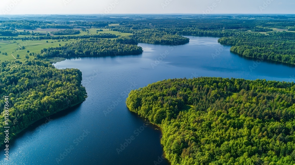 Naklejka premium A large body of water surrounded by trees