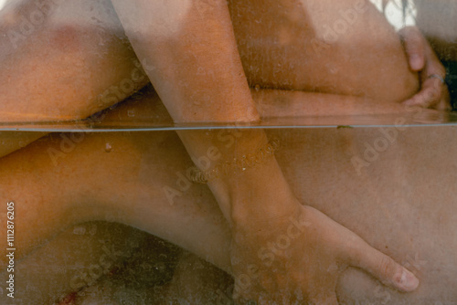 Couple embracing in a serene underwater setting during sunset photo