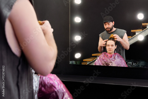 Professional hairstyling in a modern salon with mirror reflection photo