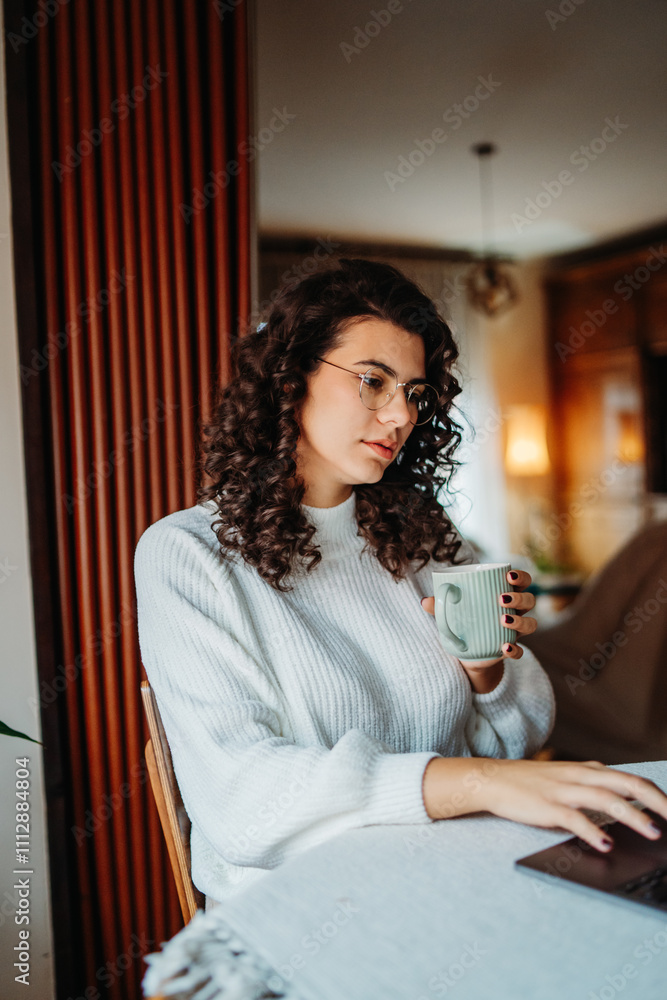 Fototapeta premium Young caucasian woman working on laptop from home 