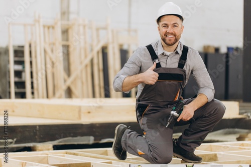 Tablou pe pânză Construction worker giving thumbs up in modular building factory