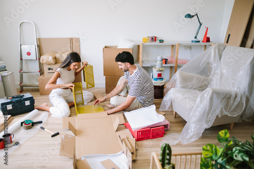  Couple assembling yellow furniture