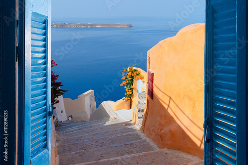 Fototapeta Naklejka Na Ścianę i Meble -  street and wooden gates against volcano caldera, beautiful details of Santorini island, Greece