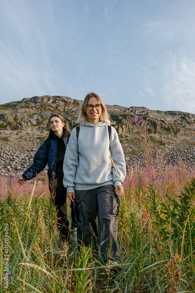 Two Women Hike Through Tall Grass on the Kola Peninsula Two Women Hike Through Tall Grass on the Kola Peninsula