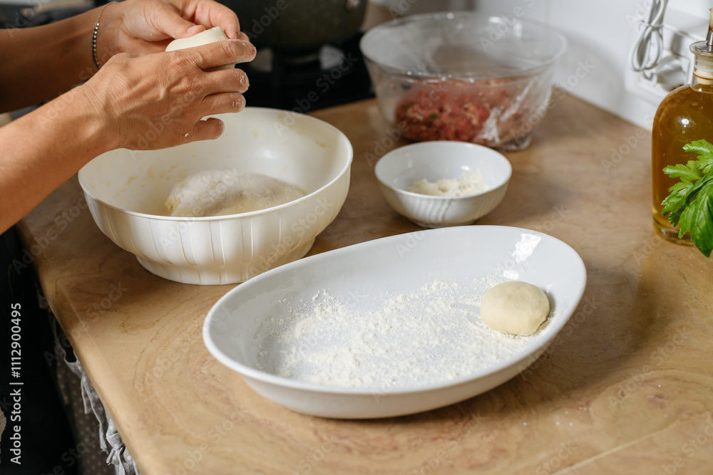 female hands preparing dough balls by filo for byrek female hands preparing dough balls by filo for byrek