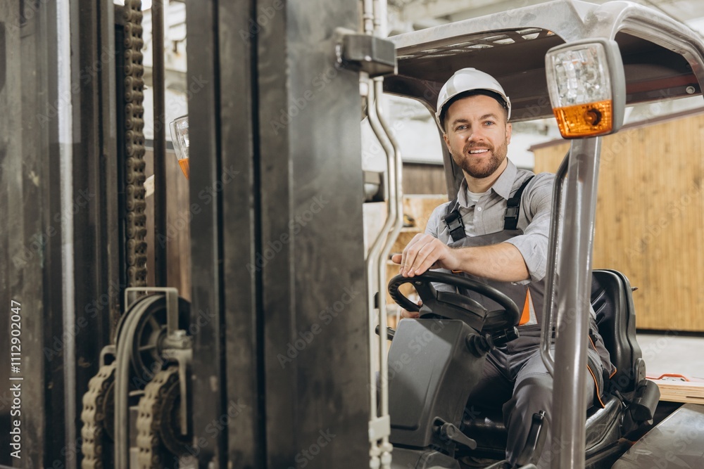 Factory worker driving forklift in modular building industry Factory worker driving forklift in modular building industry