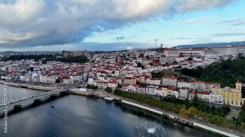 4K drone video footage of Coimbra city old town on the hill. Panoramic aerial cityscape of Coimbra university and Mondego River, Portugal