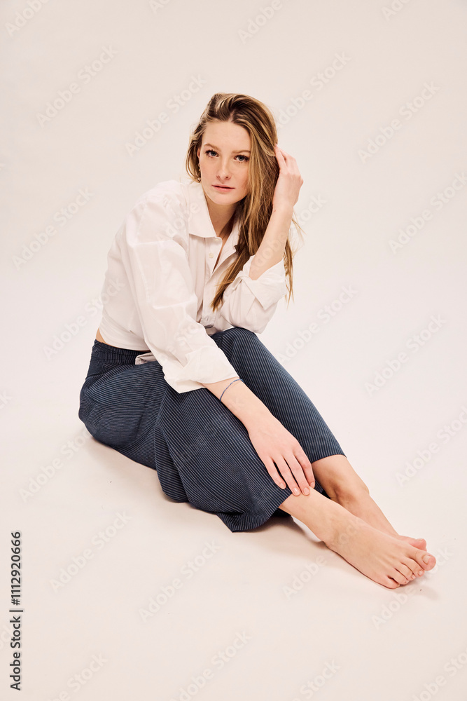 Portrait of elegant young woman in studio fashion setting. Portrait of elegant young woman in studio fashion setting.