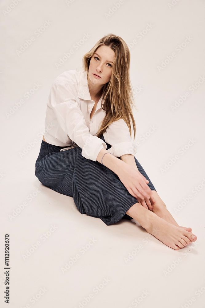Portrait of elegant young woman in studio fashion setting. Portrait of elegant young woman in studio fashion setting.