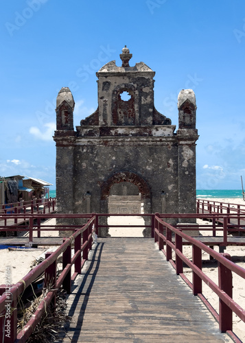 The Dhanushkodi Church, nestled in the ghost town of Dhanushkodi, Tamil Nadu, stands as a hauntingly beautiful relic of the past. Selective focus on foreground photo