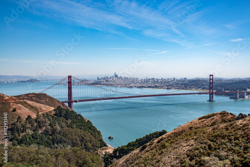 Golden Gate Bridge spanning San Francisco Bay with the city skyline and Alcatraz Island in the background.
