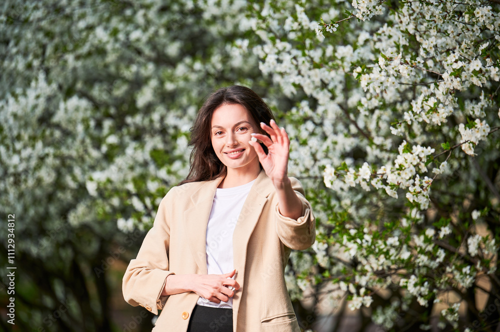 Woman allergic suffering from seasonal allergy at spring. Young happy woman showing pill, posing in blossoming garden at springtime. Antihistamine medication concept Woman allergic suffering from seasonal allergy at spring. Young happy woman showing pill, posing in blossoming garden at springtime. Antihistamine medication concept