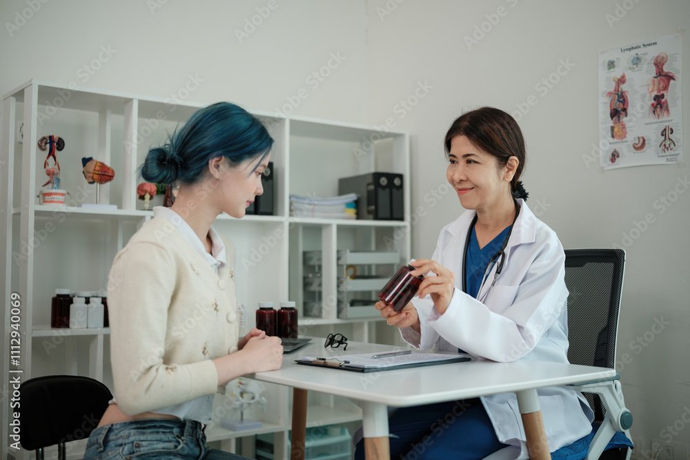 Fototapeta premium A woman is sitting at a desk with a doctor