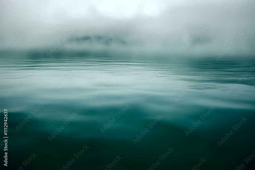 Serene misty lake landscape; calm water reflecting a foggy mountain scene, creating a tranquil atmosphere. Serene misty lake landscape; calm water reflecting a foggy mountain scene, creating a tranquil atmosphere.