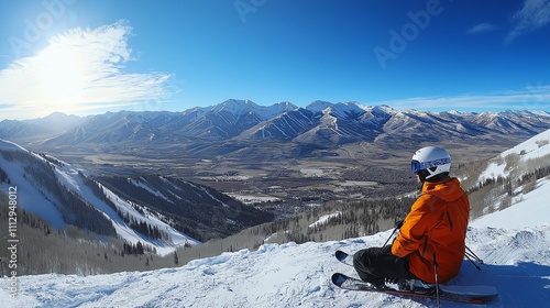 skier at top of mountains, crisp sky in the background, capturing the thrill of winter adventure photo