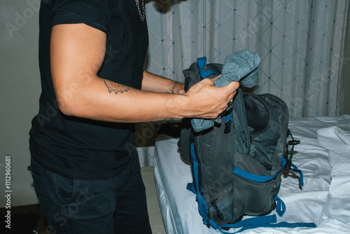 Man folding clothes neatly for trip photo