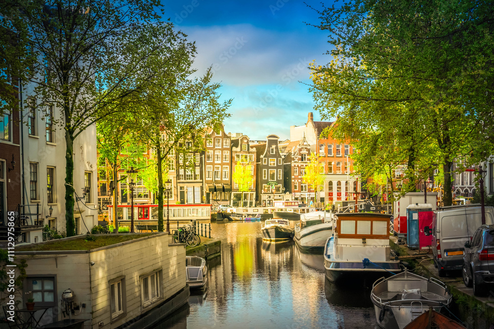 Fototapeta premium Facades of old historic Houses and trees over canal water, Amsterdam, Netherlands