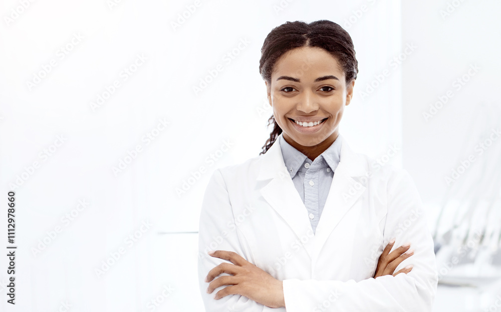 Stomatologic Services. Smiling Black Female Dentist Doctor In Uniform Posing In Modern Clinic Interior, African American Stomatologist Lady Standing With Folded Arms And Smiling At Camera, Panorama Stomatologic Services. Smiling Black Female Dentist Doctor In Uniform Posing In Modern Clinic Interior, African American Stomatologist Lady Standing With Folded Arms And Smiling At Camera, Panorama