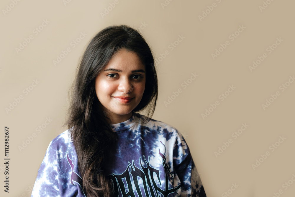 Portrait of Indian woman against beige backdrop. Portrait of Indian woman against beige backdrop.