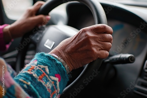 A close-up shot of a person holding a steering wheel, focusing on their grip and concentration photo