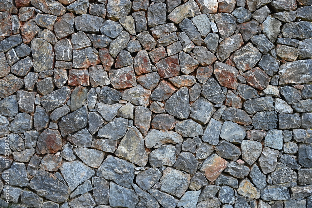 a stone wall, a stone wall built by hand by stacking stones on top of each other a stone wall, a stone wall built by hand by stacking stones on top of each other