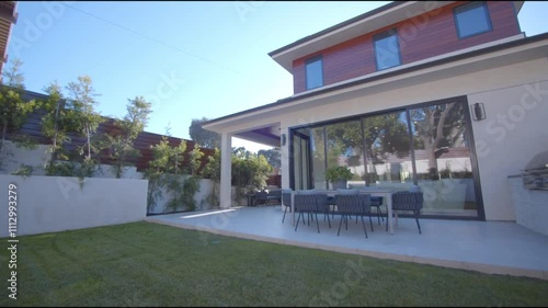 Modern California Home's Backyard Patio with Dining Set and Built-in Grill