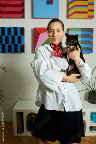 Portrait of a woman holding a small dog photo