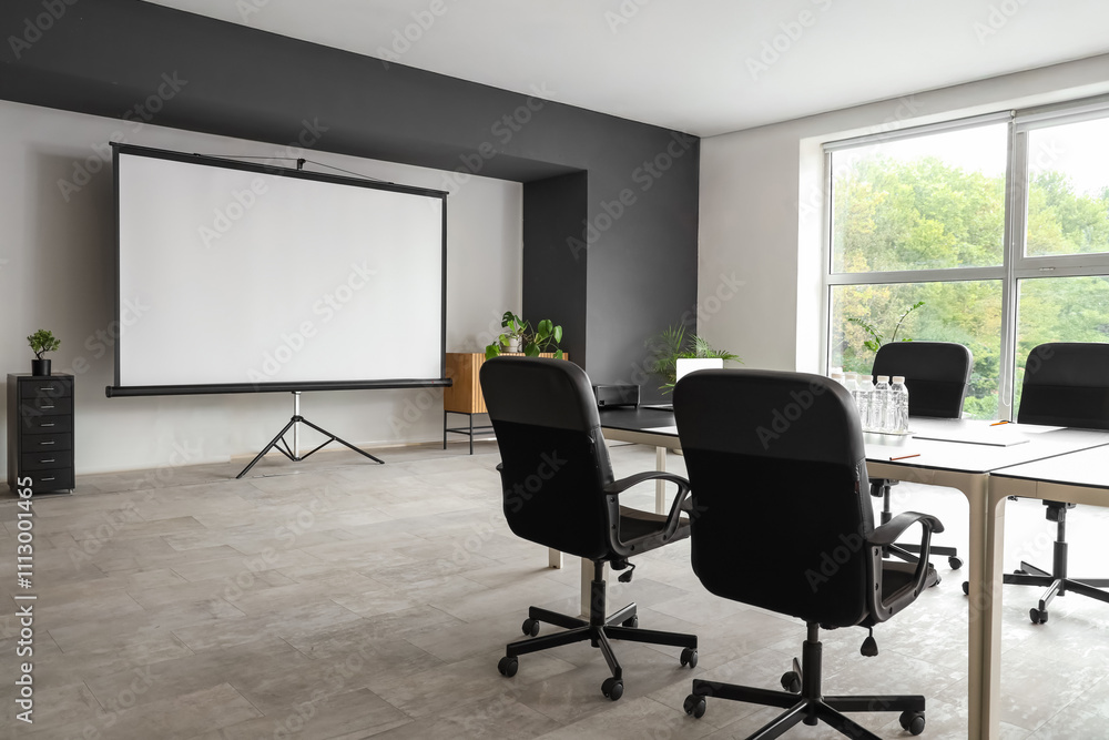 Interior of conference hall with table and projector screen Interior of conference hall with table and projector screen
