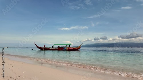 Santa Cruz island in Mindanao, Philippines. Tourists longtail boat approaching beach. photo