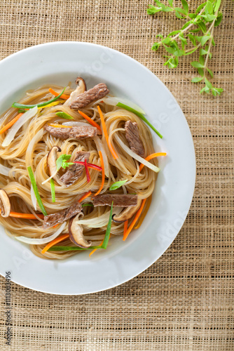 Japchae, Savory Sweet Dish of Stir-fried Noodle and Vegetables in Korean Style Cuisine with Meat, Mushrooms, Seasons
