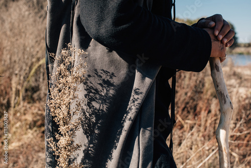 anonymous man with wood stick walk at nature photo