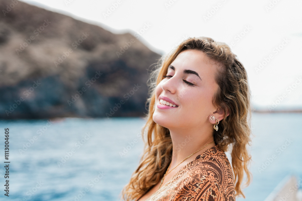 One young blonde and beautiful young woman looking and enjoying summer days in vacation holiday having fun in catamaran boat sailing in the water of sea. One young blonde and beautiful young woman looking and enjoying summer days in vacation holiday having fun in catamaran boat sailing in the water of sea.