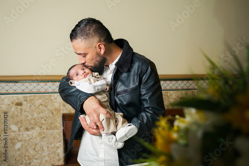 Man gives a tender kiss to a baby